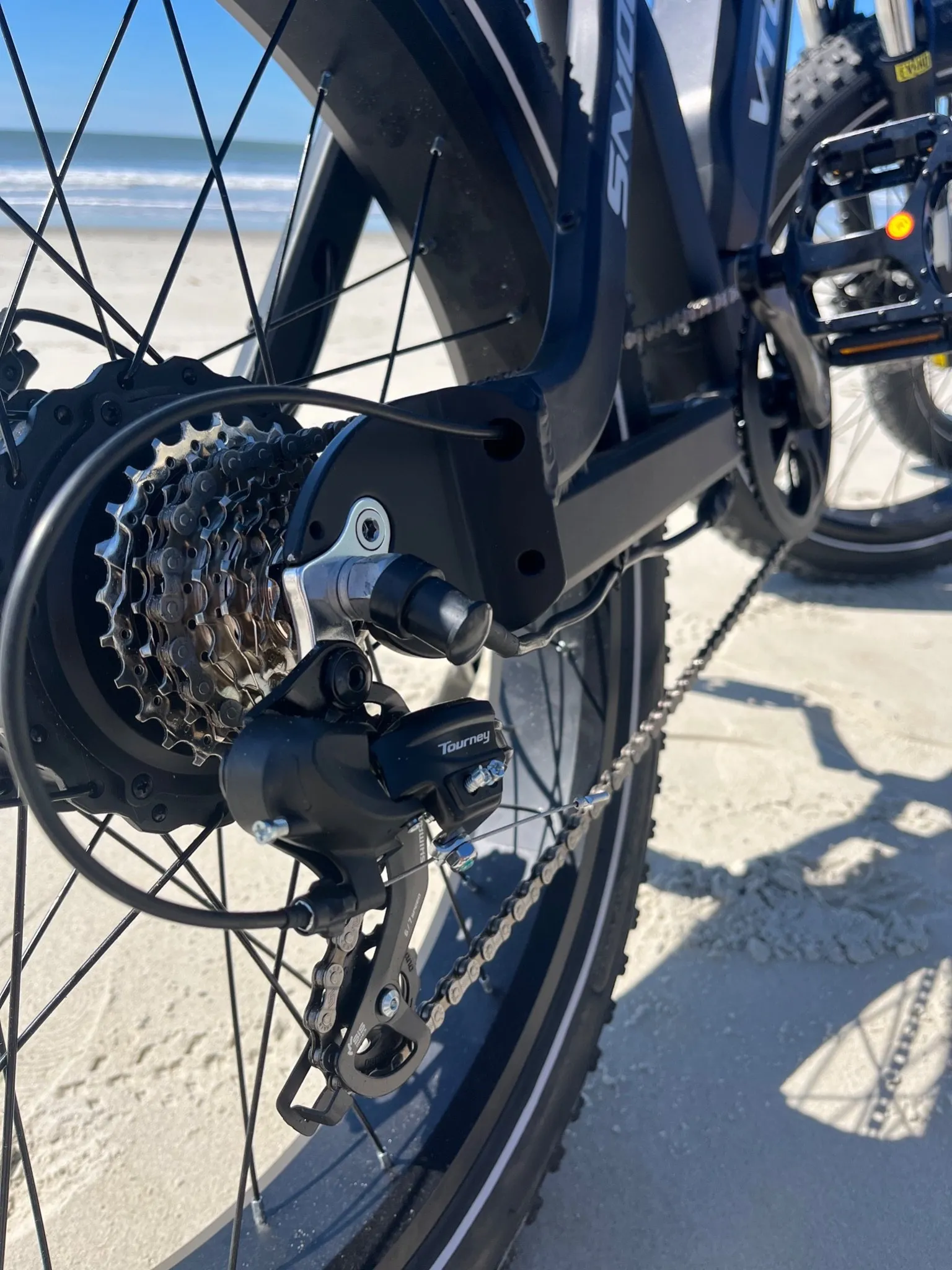 Close-up of the rear gear cassette and derailleur on a dark e-bike